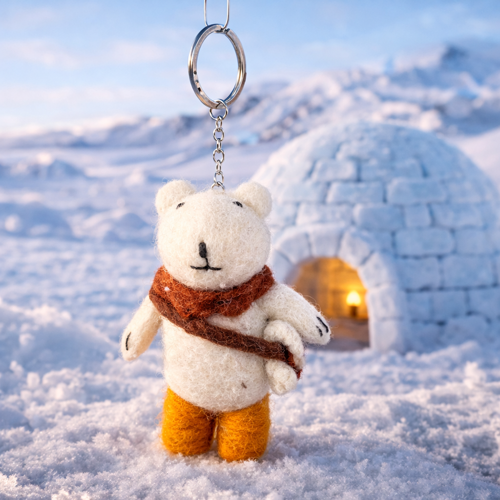 White bear keychain with a brown scarf and orange pants 